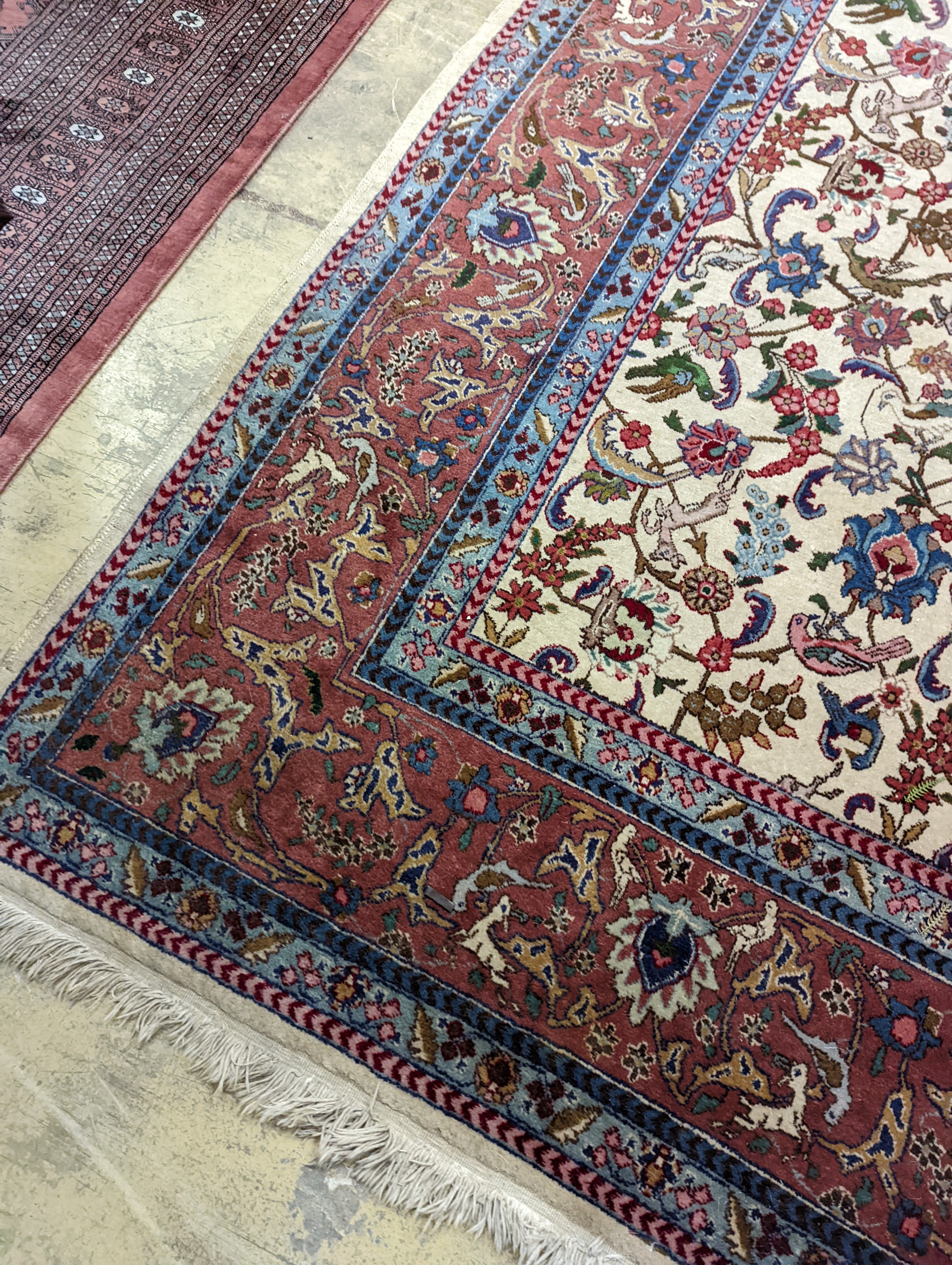 An Ispahan ivory ground carpet woven with flowers and animals, 386 x 276cm